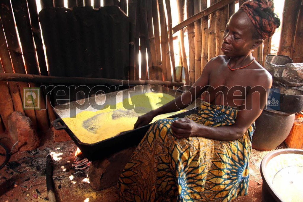 Esther Ijeabo, 54, frying gari, a staple eaten in southern Nigeria, at the back of here house in Ute Erumu town in Agbor, Delta State, Esther has been in the business since she was a young teenager . Photo By Emmanuel Osodi